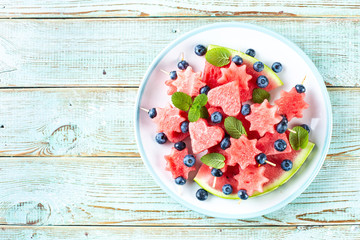 watermelon slices in the shape of hearts and stars. food background. space for a text