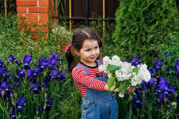 portrait of a little girl with a bouquet of white lilac