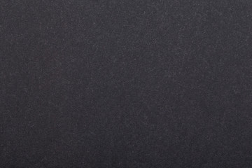 Texture of dark paper. Background for images. copyspace. space for text. sheet of gray craft paper as background. black paper