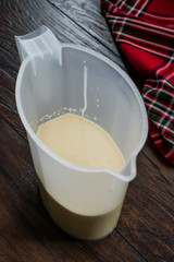 Raw Pancake Dough in Plastic Carafe Ready to Pour on Pan.