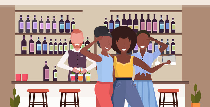 african american girls taking selfie photo on smartphone camera people relaxing in bar drinking cocktails barman serving clients modern cafe interior flat horizontal portrait