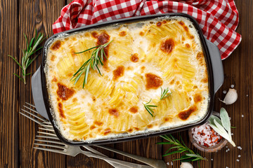 Potato gratin. Baked potato with cream, cheese and garlic