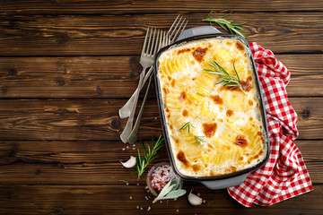 Potato gratin. Baked potato with cream, cheese and garlic