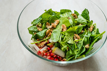 Fresh Walnut Salad with Pomegranate and Pear Slices in Glass Bowl. Ready to Make.