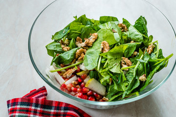 Fresh Walnut Salad with Pomegranate and Pear Slices in Glass Bowl. Ready to Make.