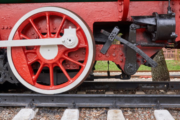 Steel wheels old steam locomotive standing on rails, vintage train, close-up
