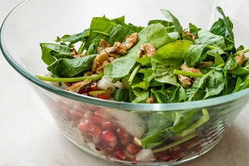 Fresh Walnut Salad with Pomegranate and Pear Slices in Glass Bowl. Ready to Make.