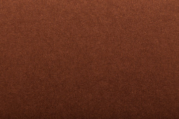 Fototapeta premium Texture of dark paper. Background for images. copyspace. space for text. sheet of gray craft paper as background. brown paper