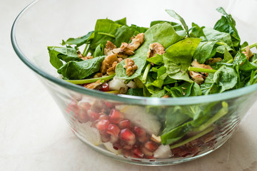 Fresh Walnut Salad with Pomegranate and Pear Slices in Glass Bowl. Ready to Make.
