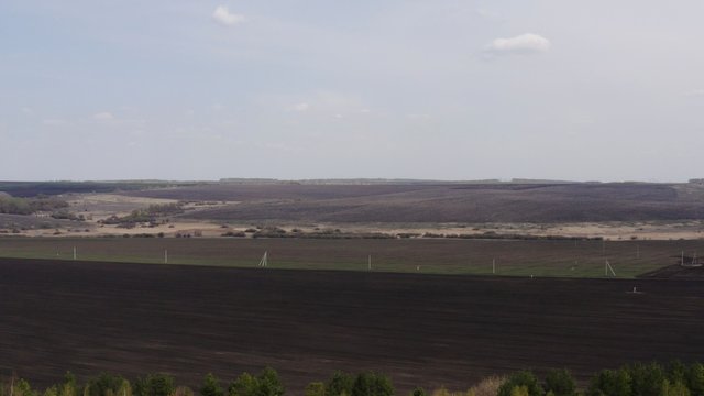 Aerial survey of arable land. Plowed field. Fertile land of arable land. Sowing. Fly over the arable land.