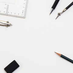 Background with white paper, pencils and eraser. Workplace for the painter. Background to display the logo and lettering. copyspace, space for text. the blogger instrument. Office tools.