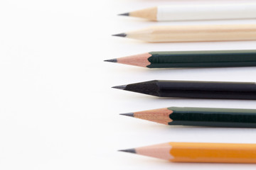 Background with white paper and pencils. Workplace for the artist and illustrator. Background to display the logo and lettering. copyspace, space for text. the blogger instrument. Office tools.