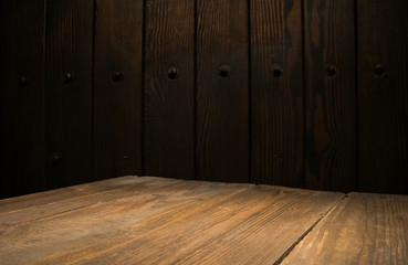 Selected focus empty brown wooden table and wall texture or old black brick wall blur background image. for your photomontage or product display