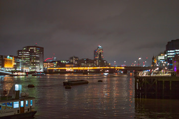 Fototapeta na wymiar London river thames at night with dark sky