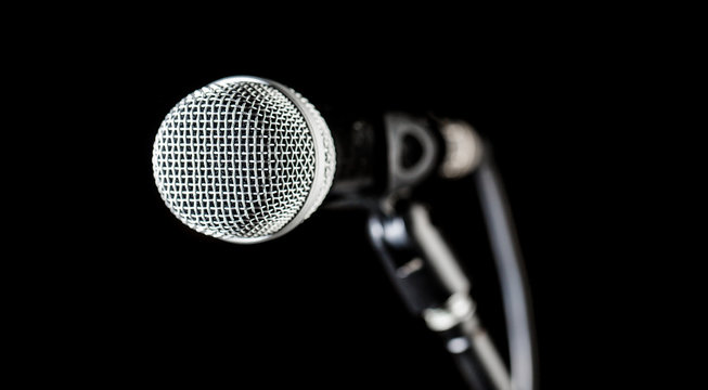 Singer in karaokes, microphones. Live music, audio equipment. Closeup microphone, macro mic, karaoke, concert, voice music. Closeup microphone. Vocal audio mic on a bleck background