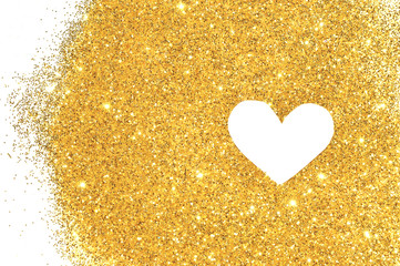 White heart on golden glitter sparkles on white background