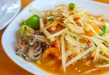 Green papaya salad Thai cuisine spicy delicious. Thai call som tam. Famous Thai food, Papaya Thai Green Papaya Salad with peanuts. 