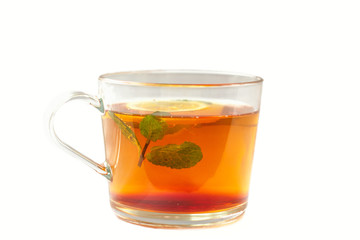 clear glass mug with mint tea and lemon on a white background