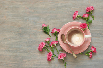 Cup of creamy coffee with flowers decor