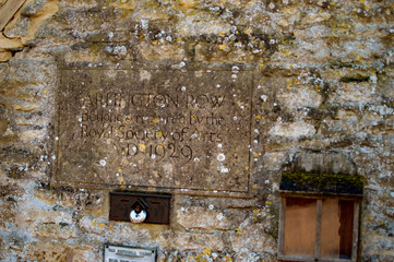 Bibury village in cotswolds and old house wall
