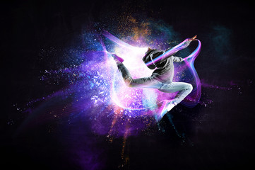 Fototapeta na wymiar Modern female dancer jumping in hoodie with colourful splashes background. Mixed media