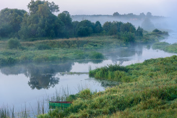 Fog on the river. Morning in the village. Russia