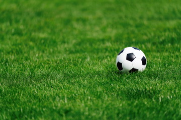 soccer ball on green grass, shallow depth of feald