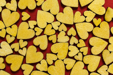  Top view of wooden hearts on red background pattern. The concept of love. Valentine's Day.