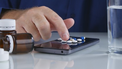 Man Choose and Take Medical Pills for Headache from Cellphone Screen Surface