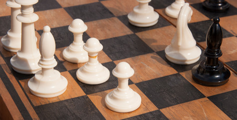 Wooden chess pieces on a chess Board