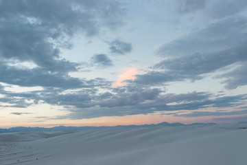 Fototapeta na wymiar pastel colored desert sunset above white sand dunes in White Sands National Park, New Mexico