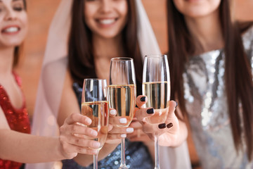 Beautiful young women drinking champagne at hen party