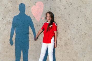 Plakat Happy dad holds daughter's hand. Shadow of dad and daughter on the wall. On the wall the inscription Dad I love you. Concept of happy father day.