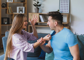 Young quarrelling couple at home