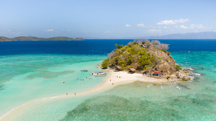 A small island for tourists with a sand bar.Tourists rest on a small island. Philippine Islands aerial view. Philippines, Palawan