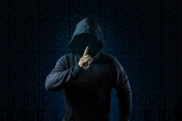 Anonymous computer hacker over abstract digital background. Obscured dark face in mask and hood. Data thief, internet attack,