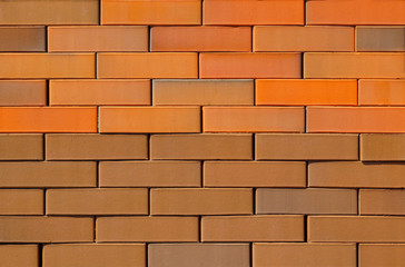 Obraz premium Tekstura ściany z cegły o różnych kolorach do budowy. W obliczu materiału budowlanego.