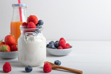yogurt with fruit on a breakfast table on a white background