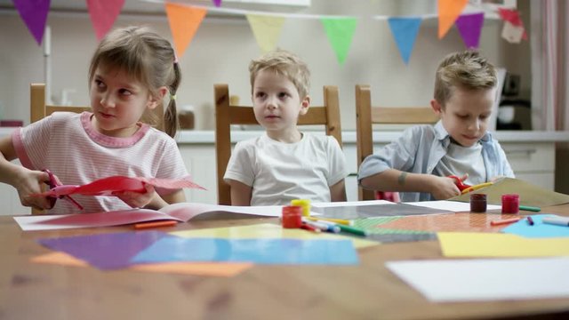 children use scissors to make applications for holidays