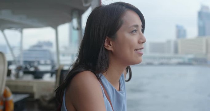 Woman take ferry in Hong Kong city