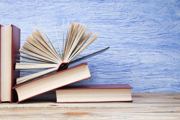open book, books on the blue background. Back to school. Education. Copy space for text.