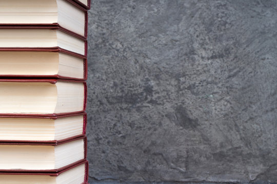 stack of books on the gray concrete background. Back to school. Education. Copy space for text.
