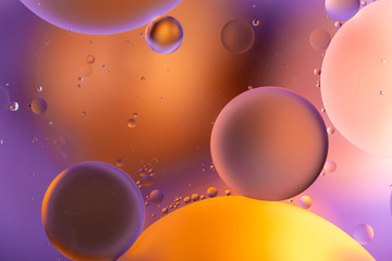 oily drops in water with colorful background, close-up 