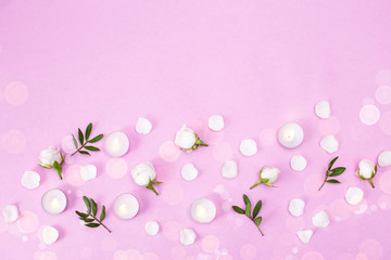 Rosebuds, petals, candles, on a pink background. Concept for a greeting card. Weddings, Valentine's Day, Birthday