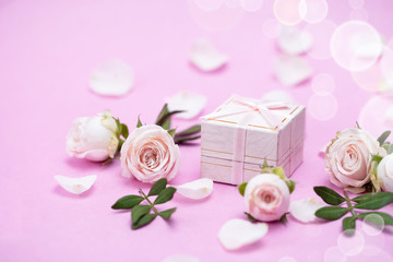 Rosebuds, petals,, gift box on a pink background. Concept for a greeting card. Weddings,...