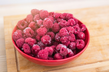 Frozen fresh raspberries on a plate.