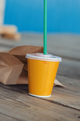 paper yellow glass with a tube for coffee