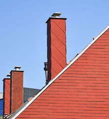 Red roof and smoke stacks of a building