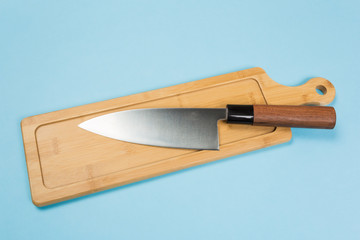 large stainless steel kitchen knife with brown wooden handle