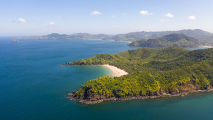 Fototapeta premium Beautiful island with a lagoon and a white beach. Seascape with islands in clear weather.Philippines El Nido aerial view